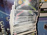 a lot of cards sitting on a table with a game in front of them