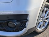 a close up of the front bumper of a white car