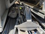 a pile of metal pipes and pipes in the back of a truck