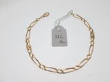 a close up of a gold chain bracelet with a price tag on it