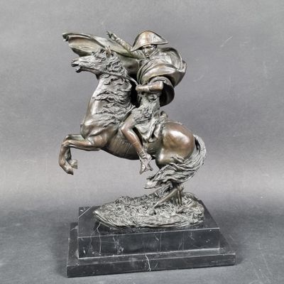 statue of a man riding a horse on a marble base