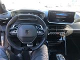 a man sitting in the driver ' s seat of a car