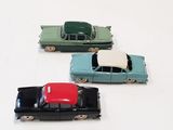 several toy cars are lined up in a row on a white surface