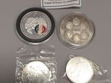 some silver coins are sitting on a table next to a sign