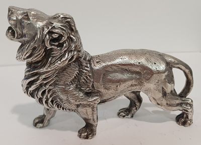 figurine de lion en argent sur fond blanc