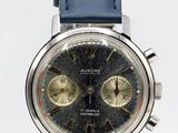 a close up of a watch with a blue strap