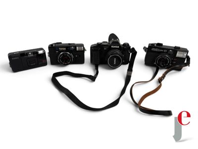 three cameras are sitting next to each other on a white surface