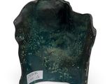 a green vase with a black base on a white surface