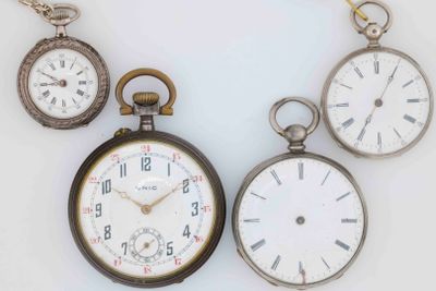 several different types of pocket watches are displayed on a white surface