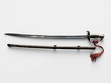 two swords with a red string tied to them on a white surface