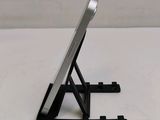 a cell phone on a stand on a white table