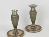 two candles that are sitting on a table