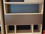a white bookcase with a blue and white shelf on top of it