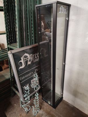 a glass display case in the corner of a room