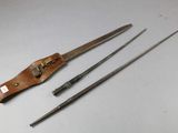 an old pair of scissors and a leather case on a table