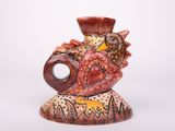 a small vase with a bird on it on a white background
