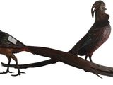 pair of metal pheasants sitting on a branch on a white background