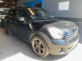 a picture of a black mini cooper parked in a garage