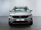 the front of a silver volkswagen suv parked in a white room