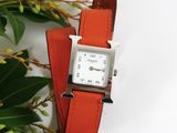 a watch that is sitting on top of a red strap