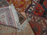 many different colored rugs laid out on the floor