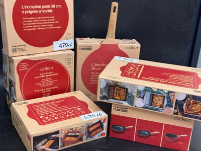 trois boîtes de nourriture sont posées sur une table, à côté d'une spatule en bois