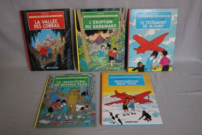 several children ' s books are lined up on a white surface