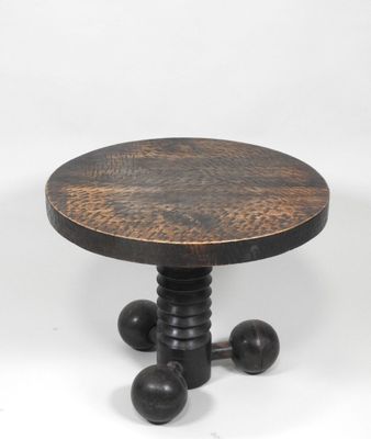 a close up of a wooden table with metal legs and a wooden top