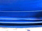 a blue purse sitting on top of a white table