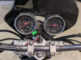 two gauges on the handlebars of a motorcycle