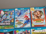 a lot of nintendo wii games on the table