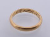 a close up of a gold ring with writing on it