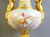 a vase with a painting of a woman playing a musical instrument on it