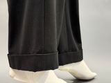 the legs of a man in black pants and white shoes