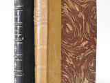 two books sitting side by side on a white surface