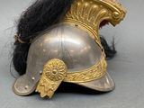 a helmet with a long black hair on top of it
