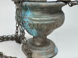 a large metal urn with a chain around it