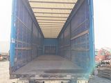 a blue truck with a flat bed in the back