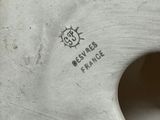 a white vase that has a hole in the middle of it