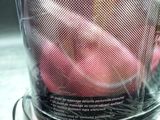 a blender filled with apples sitting on top of a counter