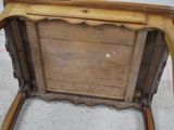 a wooden chair that has a wooden seat on it