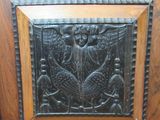a close up of a wooden door with a carving on it