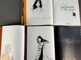 three books with drawings of a woman in a dress and a man in a coat