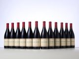 six bottles of red wine lined up in a row