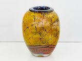 a yellow vase with a blue top sitting on a white surface