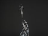 a clear glass bird sitting on top of a black surface