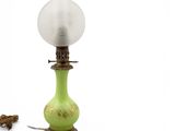 a green lamp that is sitting on a table