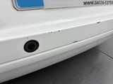 the rear end of a white car with a sticker on it