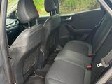 the back seat of a car with the door open and the passenger seat down