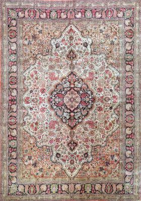 an antique persian rug with a medallion design on a pink background